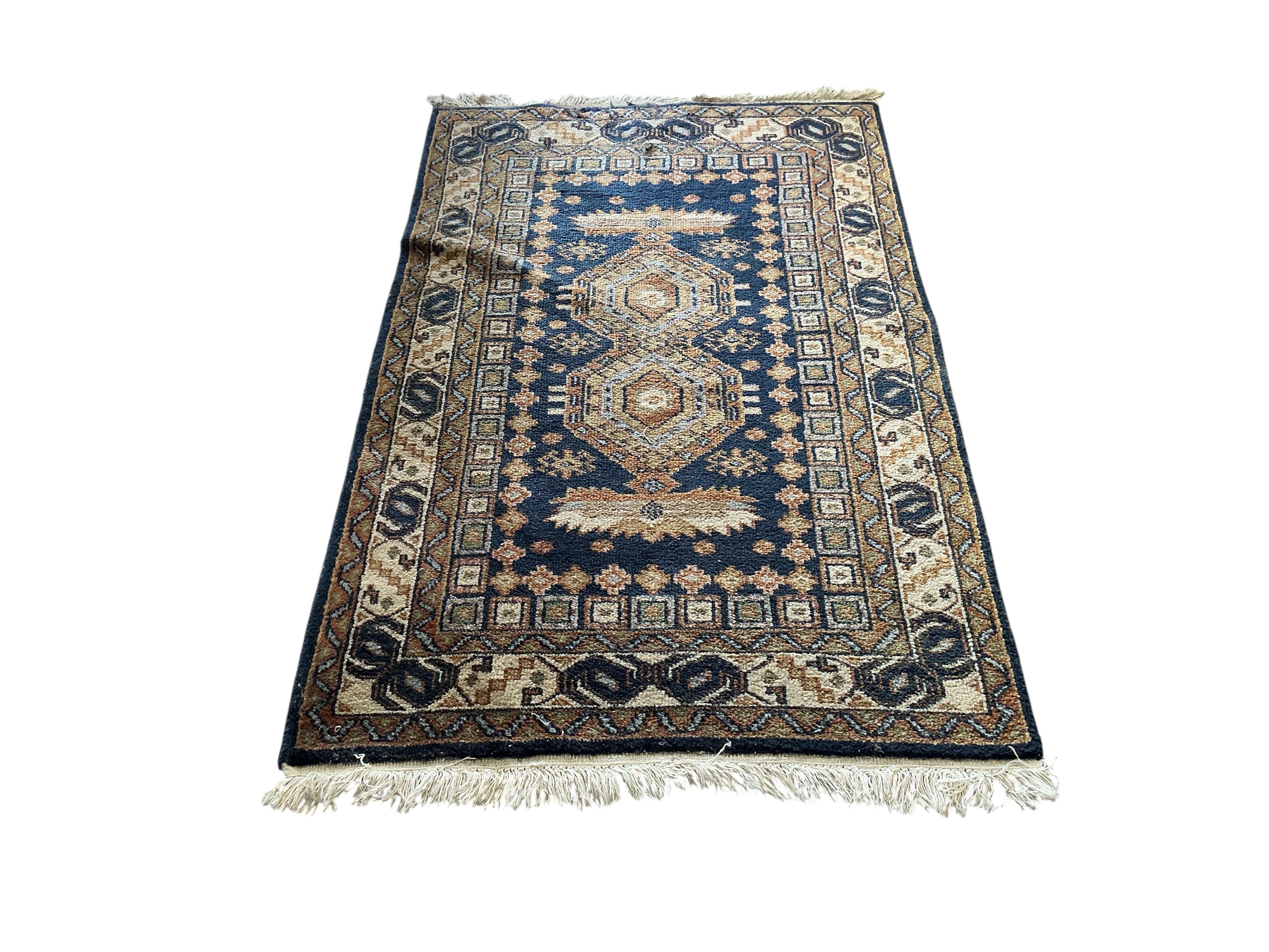 A Bokhara carpet and a smaller Caucasian style rug, larger 290 x 186cm